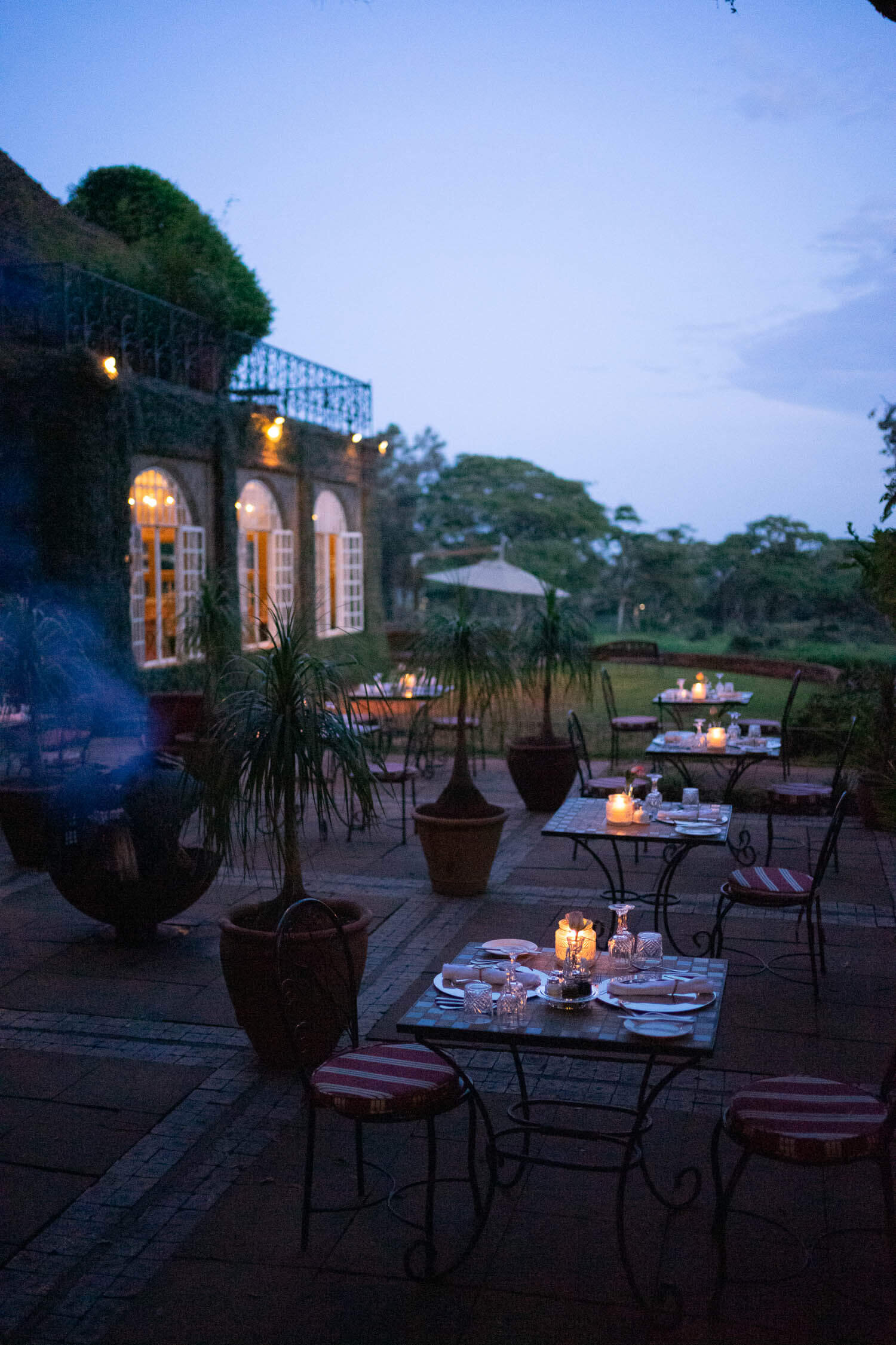 Giraffe-manor-evening-dinner-patio-table-settings-by-firepit.jpeg